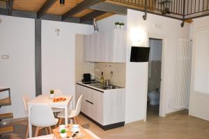 a kitchen and dining room with a table and a sink at Carpe Diem Matera in Matera