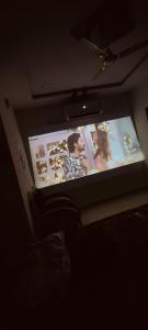 a tv screen with a man and a woman on it at Krishna Residency in Hyderabad