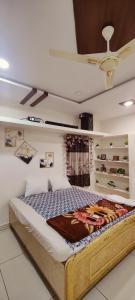 a bed in a room with a ceiling fan at Krishna Residency in Hyderabad