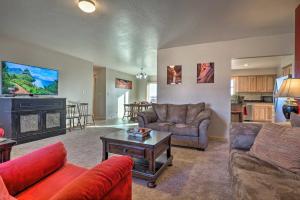 a living room with couches and a flat screen tv at Desert Retreat Basecamp for Zion, Bryce and Grand Canyon in Kanab