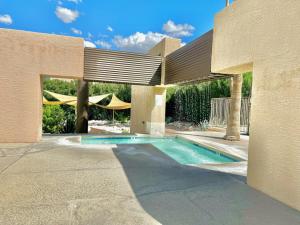 a house with a swimming pool in a yard at Sabino Canyon Condo with a Pool and Spa in Tucson