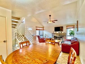 a living room with a dining room table and a fireplace at Sabino Canyon Condo with a Pool and Spa in Tucson