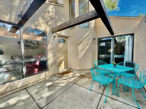 a blue table and chairs on a patio at Sabino Canyon Condo with a Pool and Spa in Tucson