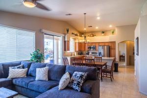 a living room with a blue couch and a kitchen at Mountain View Beauty with Pool in Tucson