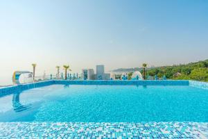 a large swimming pool with blue tiles on it at NEMO PREMIUM PENTHOUSE Odesa in Odesa