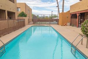 een groot blauw zwembad in een appartementencomplex bij Casa Club Condo in Tucson