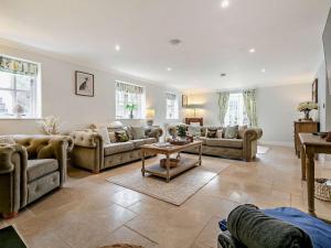 a large living room with couches and a table at Rose Cottage in Saint Hilary