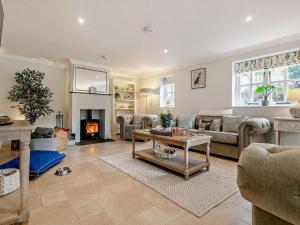 a living room with a couch and a table at Rose Cottage in Saint Hilary +19 photos