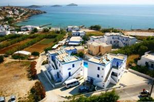 an aerial view of a large white house next to the ocean at Armenaki in Azolimnos Syros