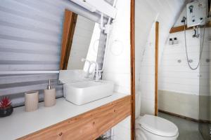 a bathroom with a sink and a toilet at Micro Casa Gótica in Florianópolis