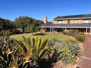 a house with a lot of plants in front of it at Bo-den-See Guesthouse in Great Brak River