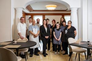 a group of people posing for a picture in a room at Hotel Posta in Comano Terme