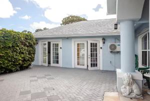 a white house with a patio in front of it at Brand new studio apartment in Vero Beach
