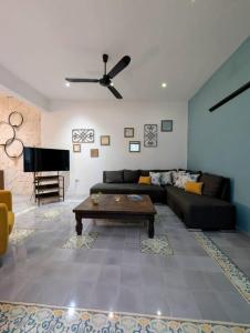 a living room with a couch and a table at Casa Kiiwik - Luxury Property with a Private Outdoor Pool and Parking in Central Merida in Mérida