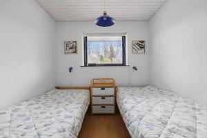 a bedroom with two twin beds and a window at 3076-Stege-Rusen-16 in Stege