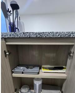 a cupboard with plates and utensils on it at Moderno Apartamento para 6 cerca de la Universidad Autónoma in Manizales
