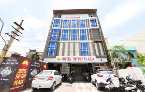 a building with cars parked in front of it at Collection O Tip Top in Jaipur