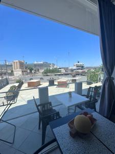 a view of a patio with tables and chairs and a large window at Nova marine 5 in Souda