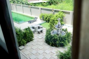 an aerial view of a patio with a fountain at Dancenter Sukhumvit 107 Bangkok Hotel in Bangkok