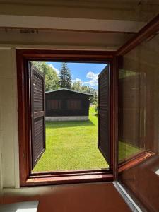 an open window with a view of a yard at Kemp Chatky Nové Město in Náchod +4 photos
