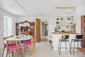 a kitchen and dining room with a table and chairs at 8217-Vordingborg-Kvaedevej-10 in Vordingborg