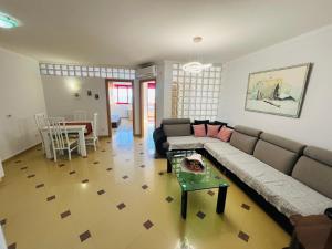 a living room with a couch and a table at Casa del Mar 2 in Durrës