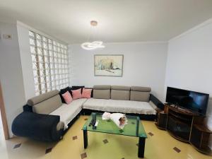 a living room with a couch and a coffee table at Casa del Mar 2 in Durrës