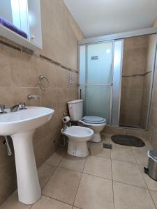 a bathroom with a toilet and a sink and a shower at Casa de montaña azul in Las Compuertas +28 photos