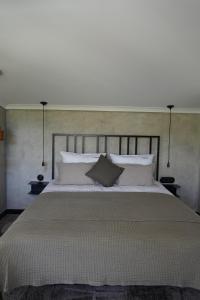 a bedroom with a large bed with white pillows at Dom w trawach in Ustrzyki Dolne