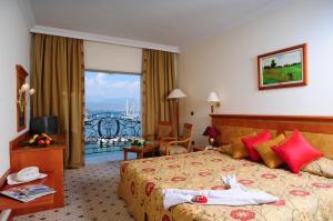 a hotel room with a bed and a balcony at Ece Saray Marina Resort in Fethiye +33 photos