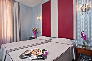 Łóżko lub łóżka w pokoju w obiekcie Hotel Relais Dei Papi
