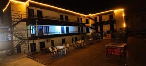 a building with a balcony with tables and chairs at Pamuklife Hotel in Pamukkale