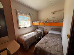 a small room with two bunk beds and a window at CAMPING VILLAGE Orsa Minore in Campo di Giove