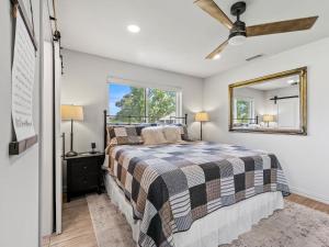 a bedroom with a bed and a mirror at Farmers Branch 10th Tee Golf Retreat in Farmers Branch