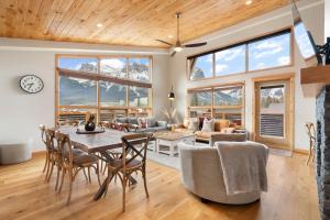a living room with a table and chairs at Spring Creek Penthouse by Canadian Rockies Vacation Rentals in Canmore