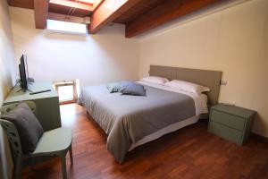 a bedroom with a large bed and a chair at AcquaRoom in Montesilvano Marina