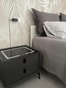 a bed with a dresser with a sink on it at La Pola House Cagliari in Cagliari