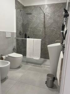 a bathroom with a toilet and a sink and a shower at La Pola House Cagliari in Cagliari