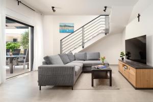 a living room with a couch and a tv at Villa Ante Vodice in Vodice