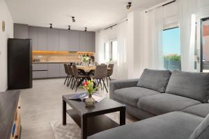 a living room with a couch and a table at Villa Ante Vodice in Vodice