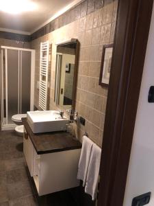 a bathroom with a sink and a toilet and a mirror at Residence Cour Maison in Pré-Saint-Didier +26 photos