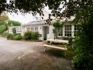 a picnic table in front of a house at Pippins in Ambleside