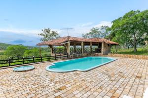 a swimming pool in a yard with a gazebo at Bela Casa com Piscina-5 Quartos-SH106D in Bezerros