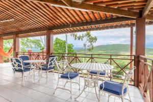 a patio with a table and chairs and a view at Bela Casa com Piscina-5 Quartos-SH106D in Bezerros
