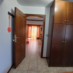 a hallway with wooden cabinets and a tile floor at Margherita's holidays home in Agios Spiridon Fokidas +32 photos