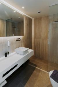 a bathroom with a white sink and a shower at Volaka Luxury Suites in Kos +130 photos