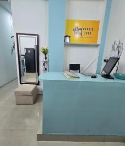 a blue counter in a room with a mirror at Bunkie Zone in Bengaluru