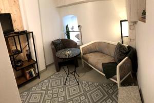 a living room with a couch and a table at Wohnung - Fisch Am kleinen Königsstuhl in Sagard