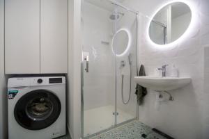 a bathroom with a washing machine and a sink at Kuca za odmor Duje in Supetar +15 photos