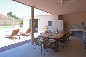 a kitchen and dining room with a table and chairs at Village Escape House by CorfuEscapes in Lefkimmi